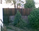 Featheredge fence adds height to a wall (dark stain)